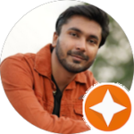 Bearded Indian man smiling calmly at camera.