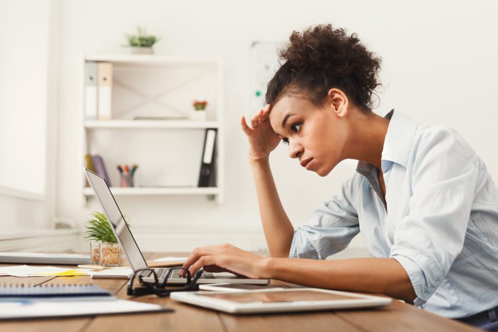 Young business woman looked at laptop working on her US company tax filing
