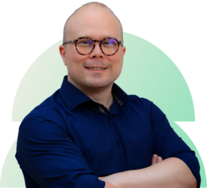 Smiling male tax specialist with glasses and shaved head.